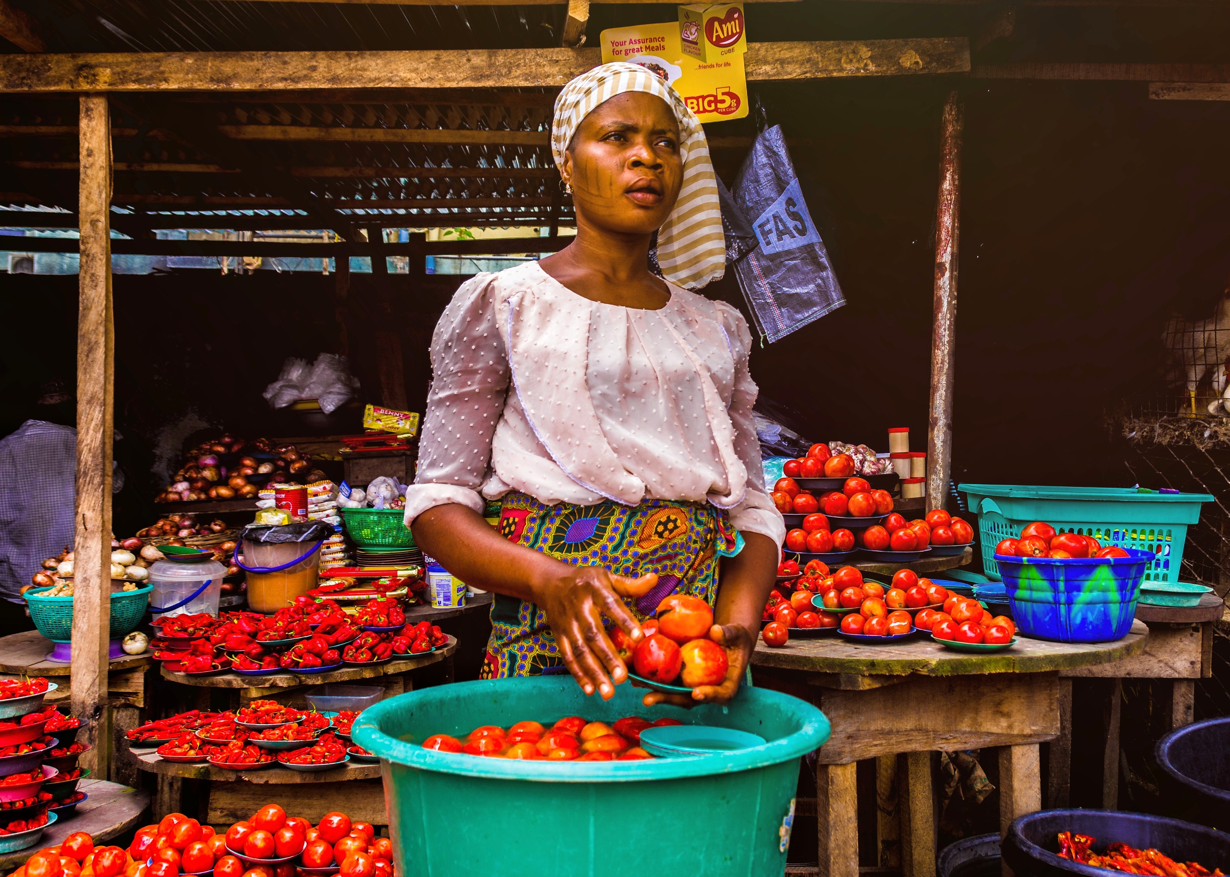 2023 - kenyan woman displaying her fresh produce