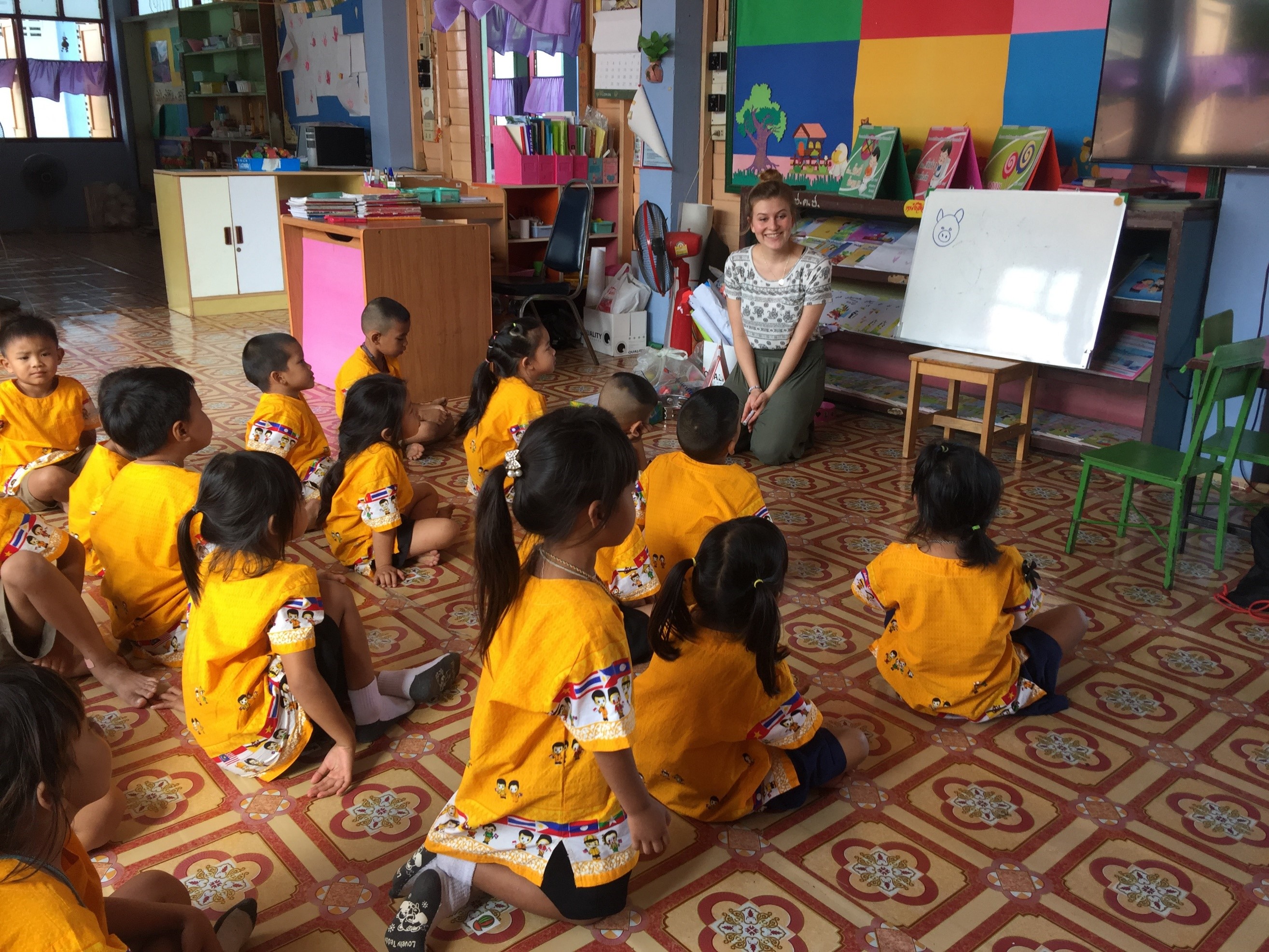 Participant teaching animal names in English with drawings