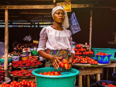 2023 - kenyan woman displaying her fresh produce